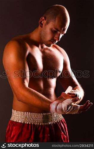strong fighter is getting ready on gray background