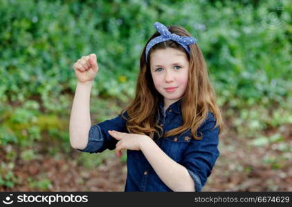 Strong girl with ten years old wearing a blue hair scarf . Strong girl with ten years old wearing a blue hair scarf enjoying of a beautiful day