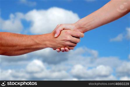 Strong handshake with a nice blue sky background