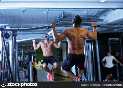 Strong handsome man exercising at the gym