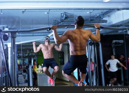 Strong handsome man exercising at the gym