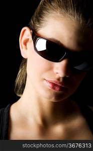 strong light studio shot of beautiful blond woman with black sunglasses