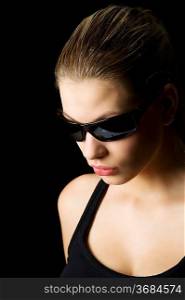 strong light studio shot of beautiful blond woman with black sunglasses