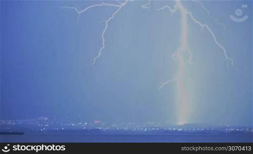 Strong lightning discharge in the night sky during the storm in the city