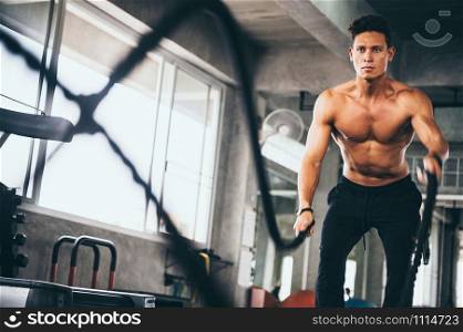 Strong man exercising in the sport gym