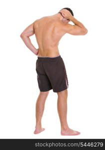 Strong man sports man showing muscles. Rear view