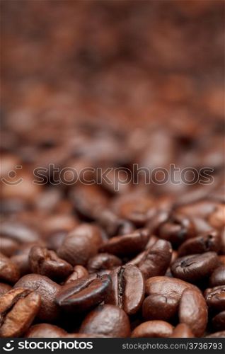 strong roasted coffee beans background with focus foreground