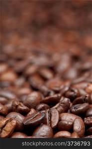 strong roasted coffee beans background with focus foreground