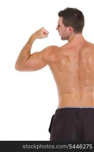 Strong sports man showing biceps. Rear view