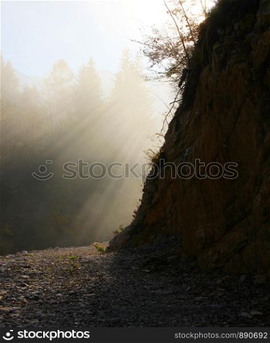 Strong sun above valley and a path