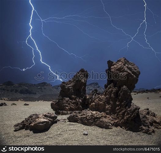 strong thunderstorm and powerful flashes of lightning against the background of the mountains.. Lightning in the mountains