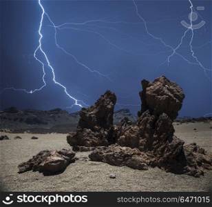 strong thunderstorm and powerful flashes of lightning against the background of the mountains.. Lightning in the mountains
