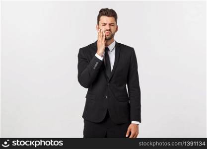 Strong toothache - businessman in pain. Portrait young adult businessman isolated against white background. Short-haired male. Strong toothache - businessman in pain. Portrait young adult businessman isolated against white background. Short-haired male.