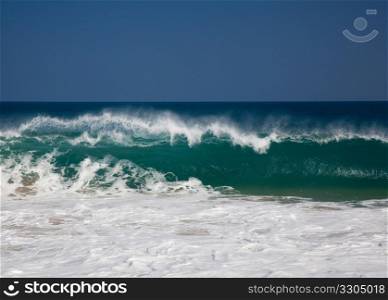 Strong waves crash over the beach at Lumahai on Kauai