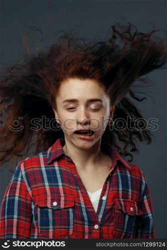 Strong wind blowing on woman&rsquo;s face, funny emotion. Powerful air flow blows on female person, black background