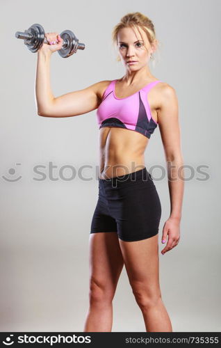 Strong woman lifting dumbbells weights. Fit girl exercising gaining building muscles. Fitness and bodybuilding.. Fit woman lifting dumbbells weights