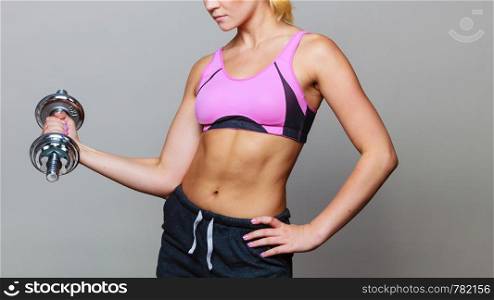 Strong woman lifting dumbbells weights. Fit girl exercising gaining building muscles. Fitness and bodybuilding.. Fit woman lifting dumbbells weights