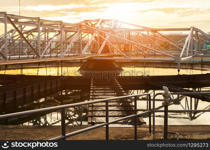 structure frame of water works in heavy industry estate plant agaisnt beautiful sunset sky light