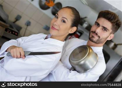 student and teacher in a professional cook school kitchen