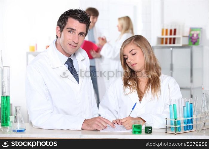 Student and teacher in chemistry class
