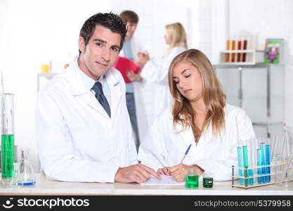 Student and teacher in chemistry class