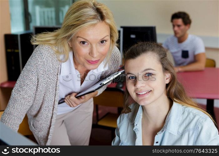 student and teacher sitting at table