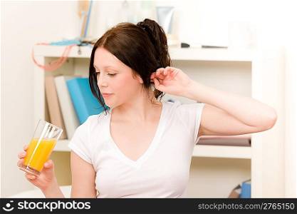 Student apartment - Young student girl drink fresh juice in morning