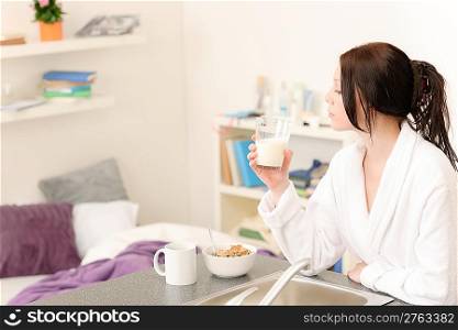 Student apartment - young student girl drink milk for breakfast