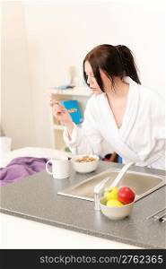 Student apartment - young student girl eat cereal for breakfast