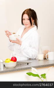 Student apartment - young student girl eat cereal for breakfast