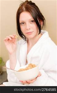 Student apartment - young student girl eat cereal for breakfast