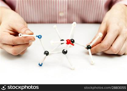 Student assembling molecule models