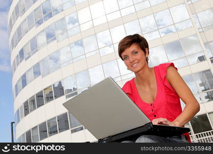 Student at college campus with laptop computer