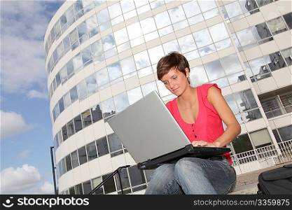 Student at college campus with laptop computer