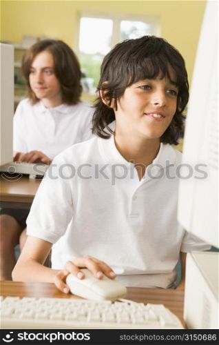 Student at computer terminal with student in background (selective focus)
