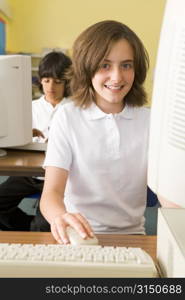 Student at computer terminal with student in background (selective focus)