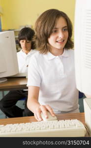 Student at computer terminal with student in background (selective focus)