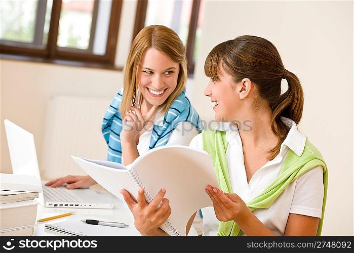 Student at home - two happy woman with laptop and book study
