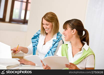 Student at home - two happy woman with laptop and book study