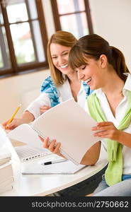 Student at home - two happy woman with laptop and book study