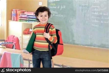 Student boy with a red backpack in the class