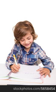 Student boy writing for homework at his desk