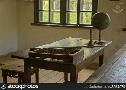 Student class in the old school with a globe and an abacus . old school