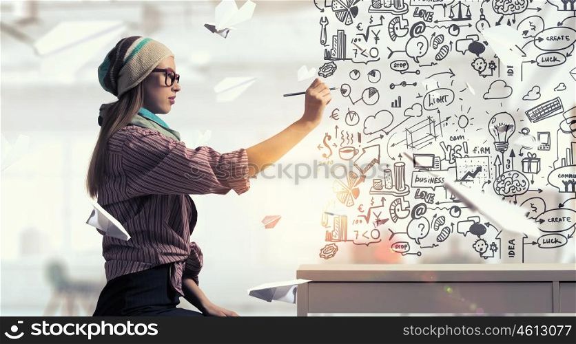 Student girl draw strategy. Hipster girl sitting at table and drawing her plan with pencil