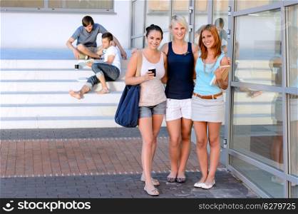 Student girl friends smiling standing front of college summer friends