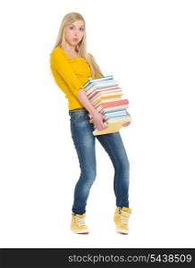 Student girl holding heavy stack of books