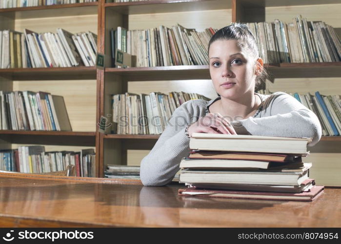 Student girl in a library. Looking at book