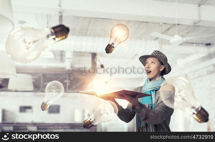 Student girl with book in hands. Young hipster girl with opened book in hands