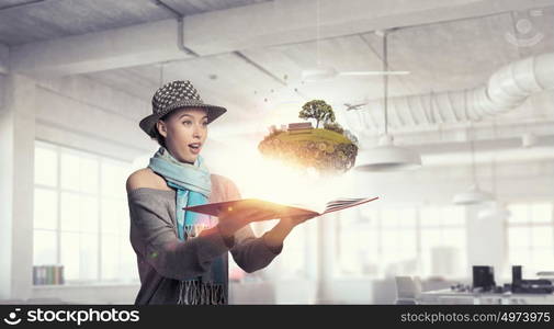 Student girl with book in hands. Young hipster girl with opened book in hands