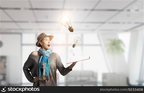 Student girl with book in hands. Young hipster girl with opened book in hands